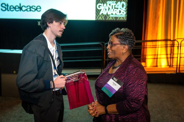 Collegiate reporter David Carpenter interviewing one of the organizers of the GIANT Awards. 