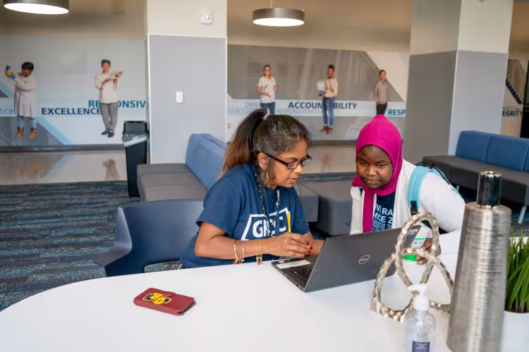 Adviser Sulari White working with a student.