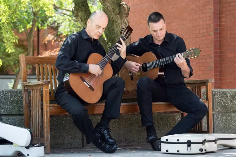 Brian Morris and Jonathan Marshall practicing with their guitars.