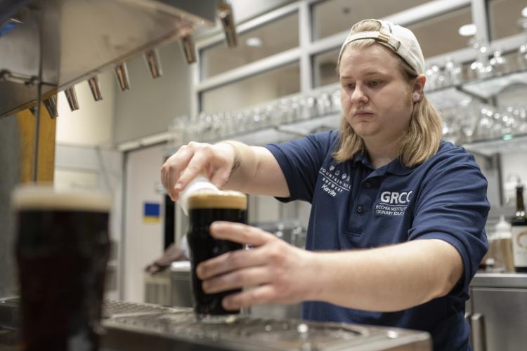A student working in the GRCC brewery.