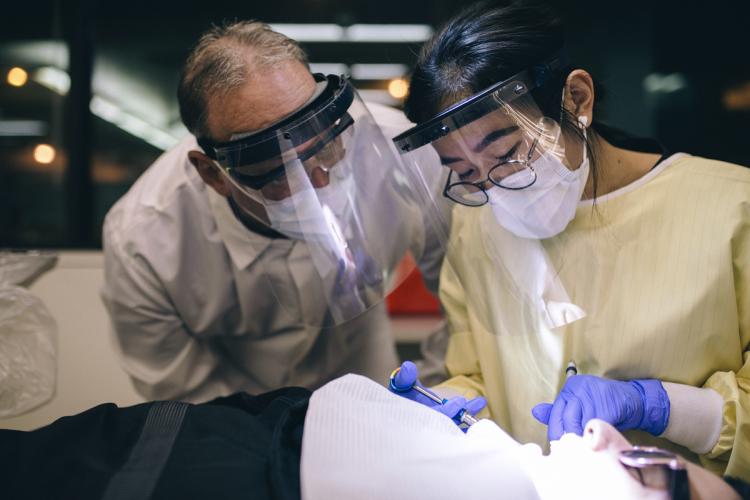 Dental student working with an instructor. 