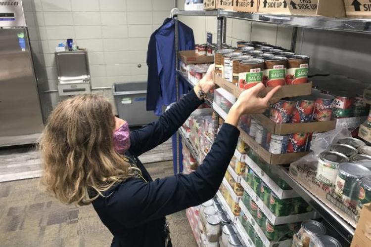 GRCC staff member Ashley Fox socks items in the campus food pantry. 