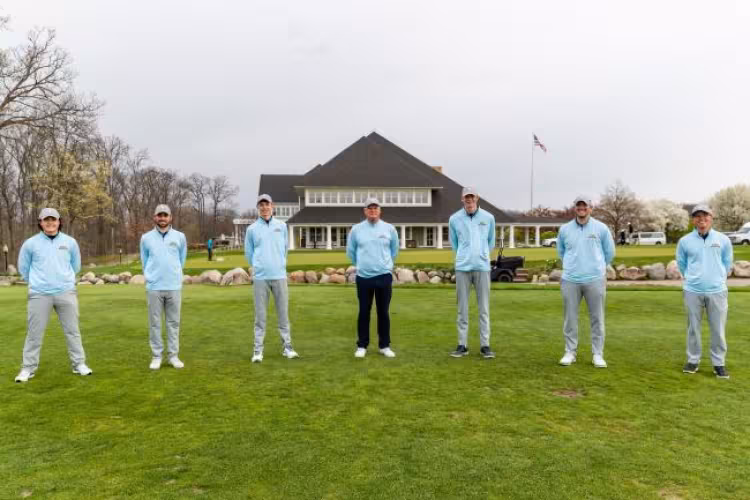 GRCC golf team members pose on a golf course