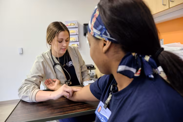 Students in the GRCC Medical Assistant program checking for a pulse.