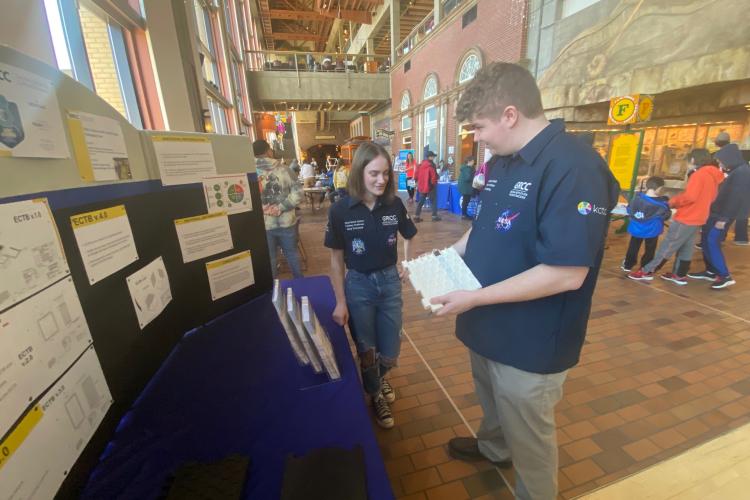 Abby Tichelaar and Cole Herring discussing their project at the Grand Rapids Public Museum.