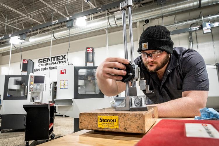 A Workforce Student working with measuring tools at the GRCC Lakeshore Campus.