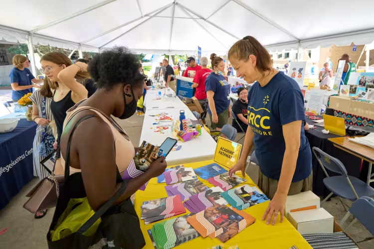 A GRCC student learning about Academic Pathways at Raider Rally.