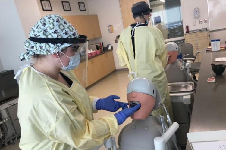GRCC Dental student working in class wearing personal protection equipment