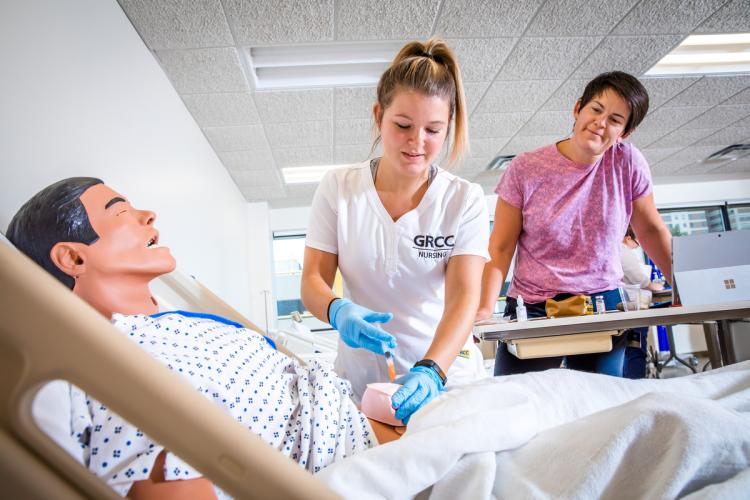 GRCC Nursing student working with a professor.