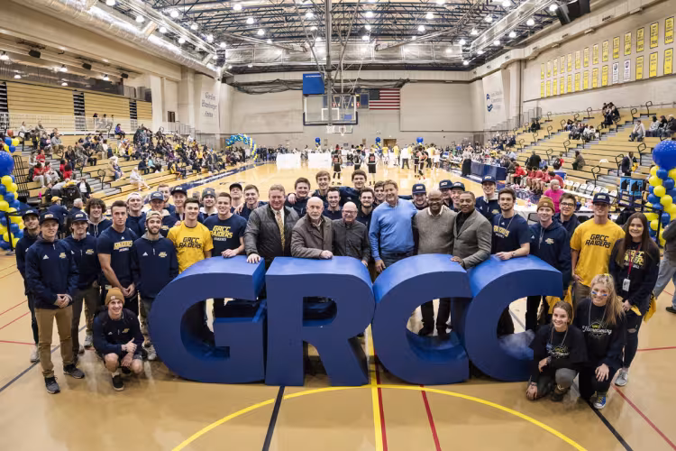 Homecoming in 2019 with athletes past and present gathered at the large letters.