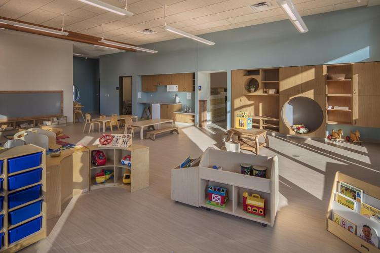 A room at the GRCC preschool with shelves and toys.