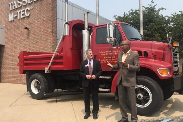 Kentwood Mayor Stephen Kepley and GRCC President Pink stand near the donated truck.