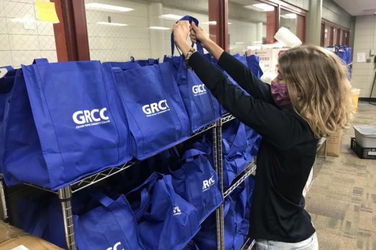 Ashley Fox helps restock the GRCC food pantry