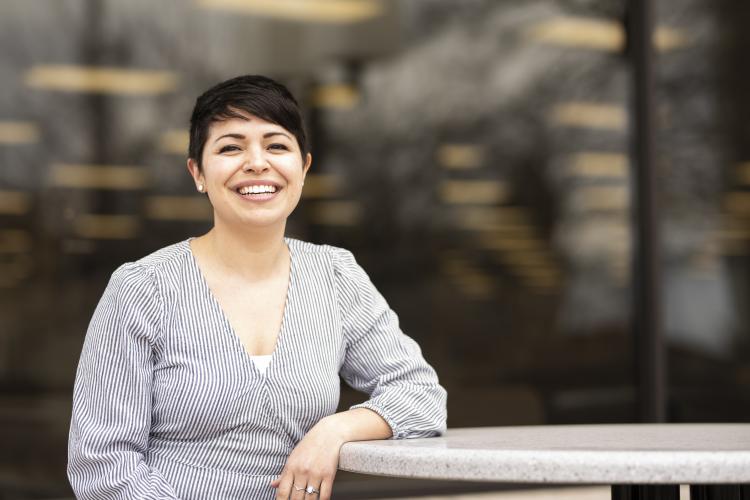 June Rayburn leans against a table in the Student Center.