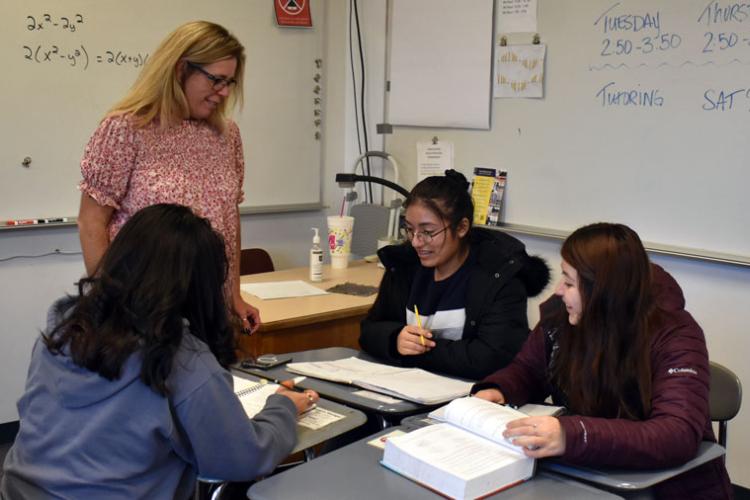 GRCC math tutor Kristine Wright hosts a tutoring session for juniors, clockwise, Annette Gonzolez, Alexsandra Cortez-Torres and Melanie Zapata.