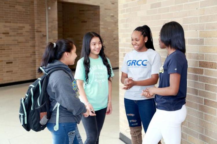 Students in Grand Rapids' Ottawa Hills High School standing in a corridor.
