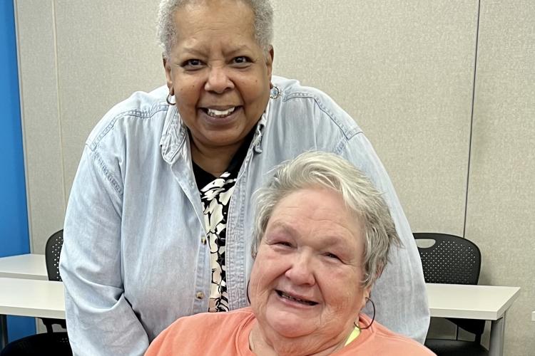Paulette Moncure and Sherry Wagner sitting together.