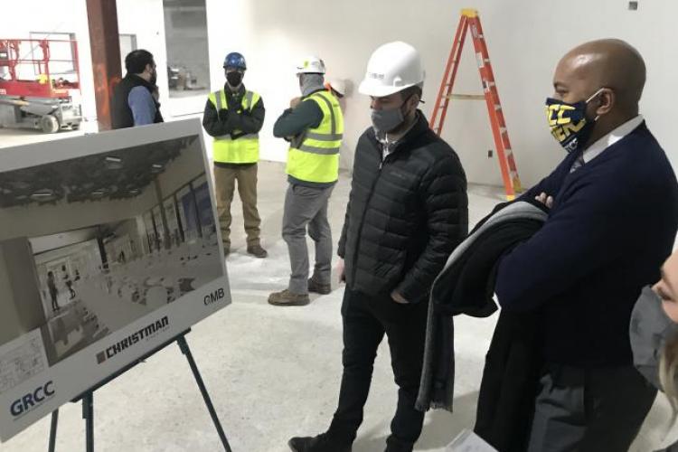GRCC President Pink looking at renderings during a tour of the Lakeshore Campus construction.