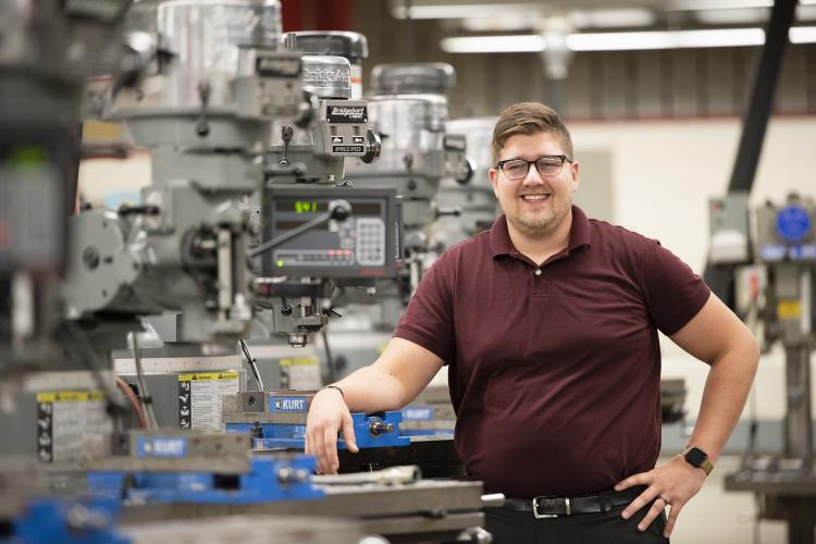 Randall Dragstra surrounded by industrial machinery.