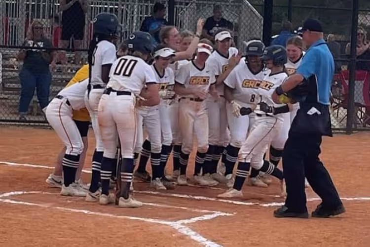 GRCC softball team celebrating after a home run.