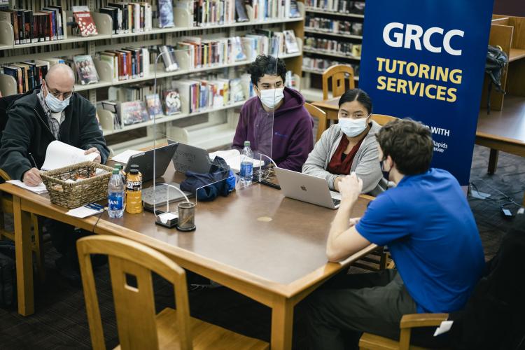 Students working with tutor Nate Reinke at the Seymour Learning Hub.