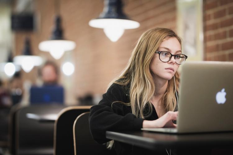 Student working on a laptop in the Sneden Cafe