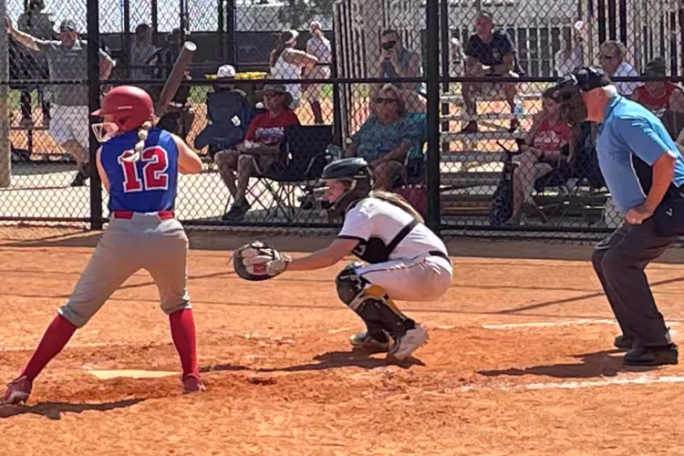 GRCC softball player catching behind the plate.