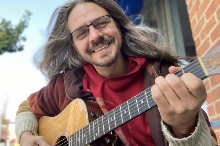 Nik Thomasma with his guitar.