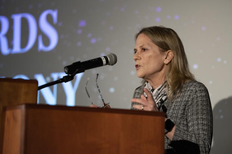 Tina Hoxie speaking at a student awards event.