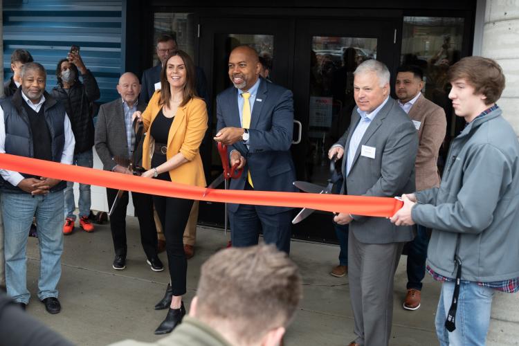 GRCC President Pink and WMCI leaders about to cut the ribbon for new facility.