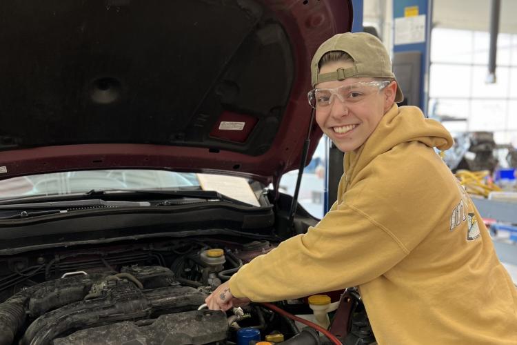 Sophia Lonnee working on a car. 