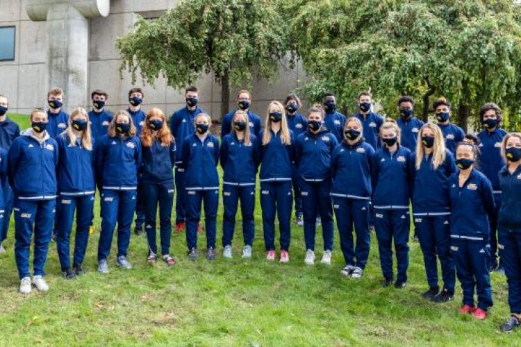 GRCC cross country teams posting for team photo, wearing face coverings for safety