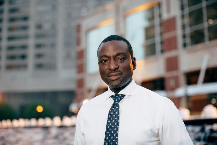 Dr. Yuseft Salaam, wearing a white shirt and blue tie.