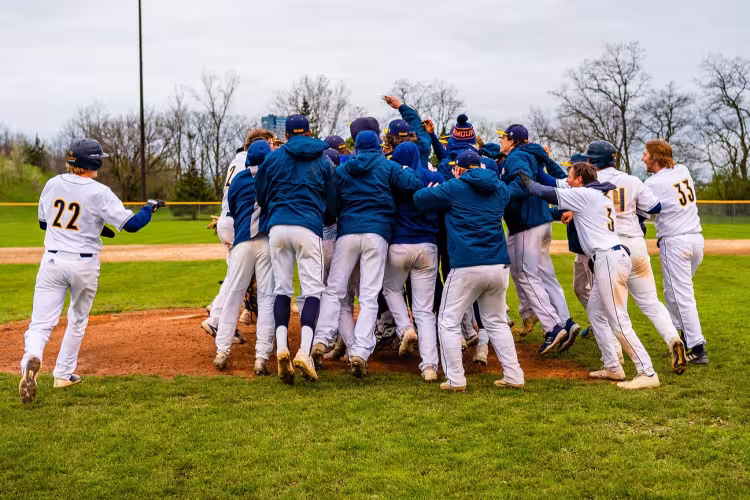 Baseball players celebrating as a group.