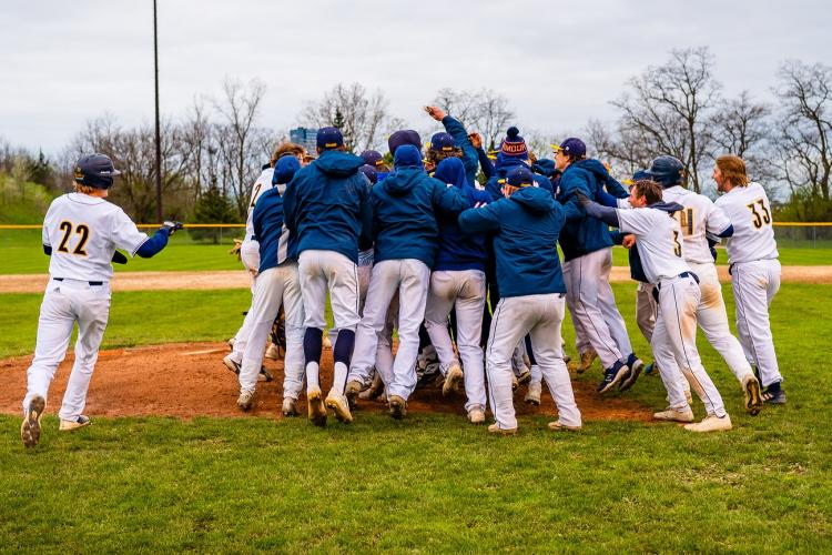 Baseball players celebrating as a group.