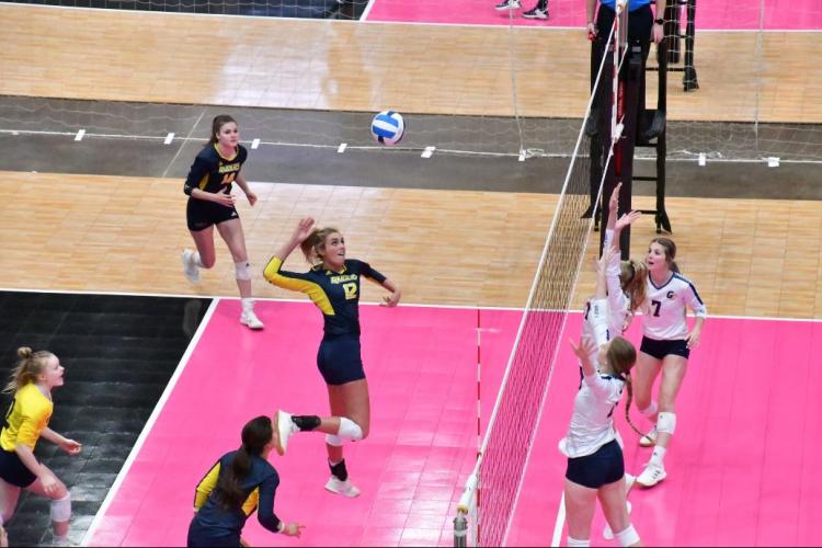 Grand Rapids basketball player leaping to return a shot.
