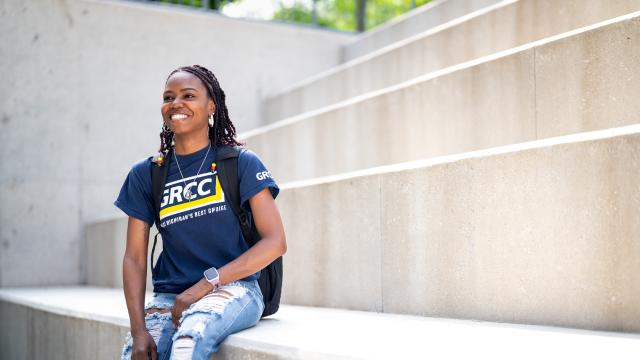Student sitting outside the library