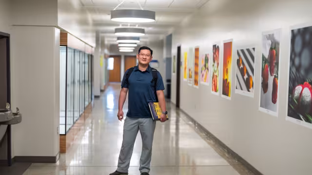 Student in the hallway in RJF 4th floor