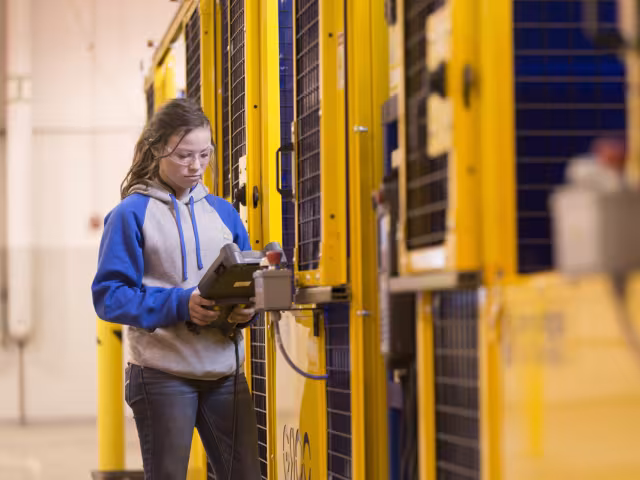 Student working with manufacturing machines