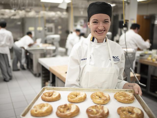 GRCC baking student holding a tray os cookies