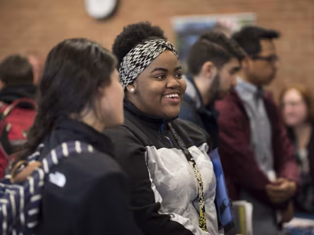 Two students talking a career fair.