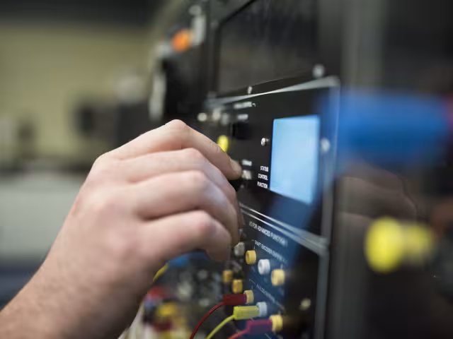 Student works on circuit board.