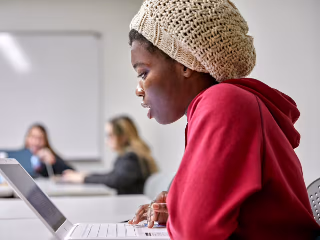 Student studying on a laptop