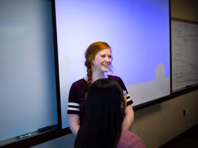 Student presenting at the front of the class