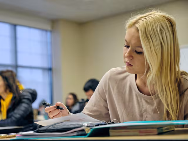 Student taking notes in class