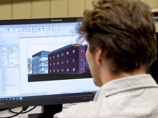 A student designing a building on a computer