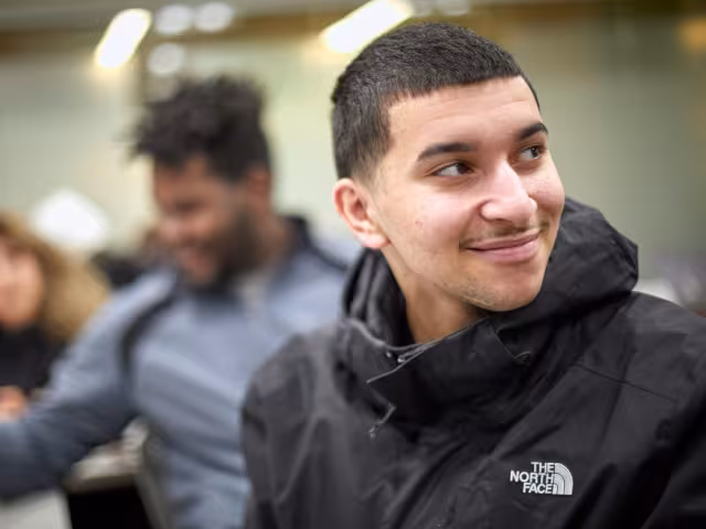 Student looking over his shoulder in a classroom