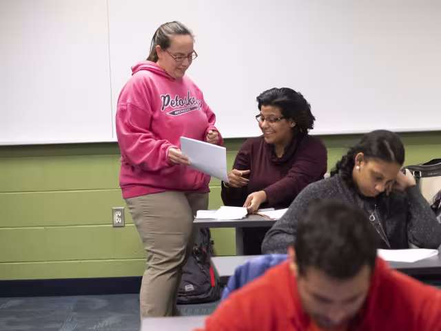 Student reviewing a paper with their professor