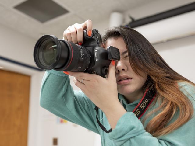 Student aims camera.