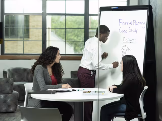 Students working on a group project for financial planning.
